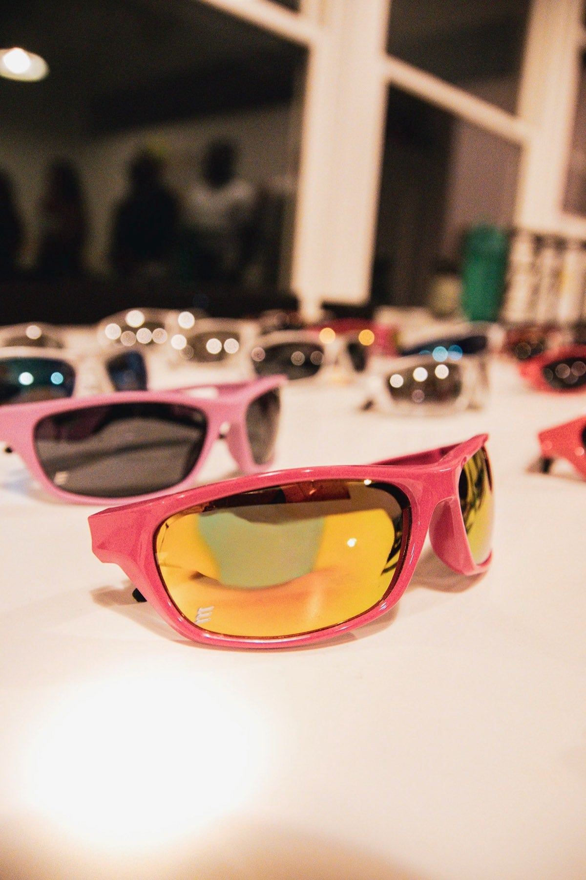 Pink Edge Movement wrap with a gold mirror lens on a display table