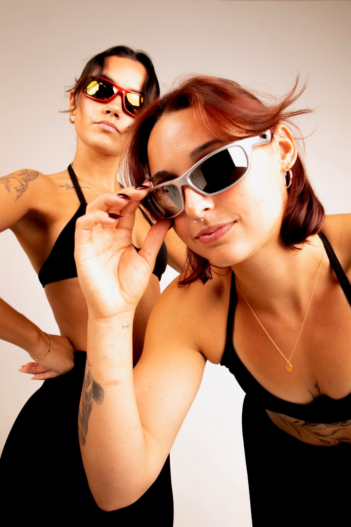Two women in Edge Movement wraps, silver frame in front